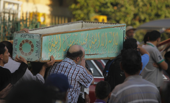 Egyptians carry the coffin of a Shi'ite victim, who was killed in sectarian violence, after funeral prayers in Cairo